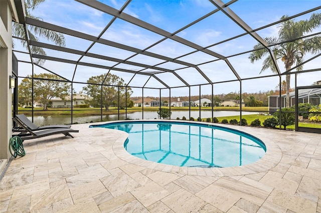 view of swimming pool with a water view, a patio area, and glass enclosure