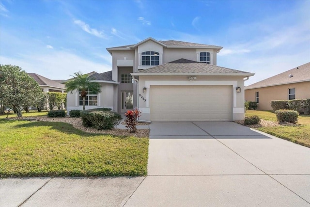 view of front property featuring a garage and a front yard