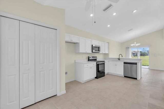 kitchen featuring kitchen peninsula, appliances with stainless steel finishes, hanging light fixtures, vaulted ceiling, and white cabinets