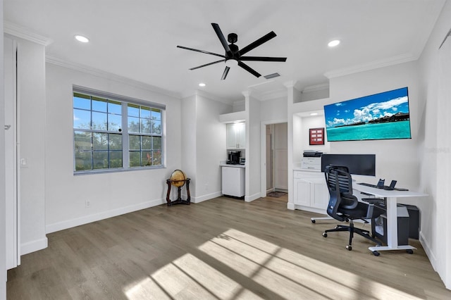 home office featuring ceiling fan, light wood-type flooring, and crown molding