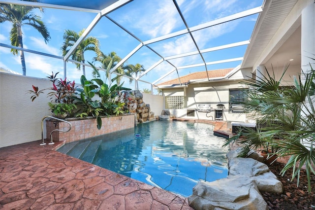 view of pool with glass enclosure and a patio