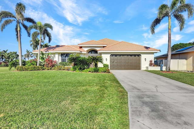 mediterranean / spanish house with a garage and a front yard