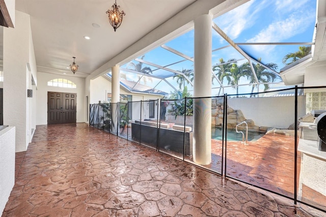 unfurnished sunroom featuring a chandelier and a healthy amount of sunlight