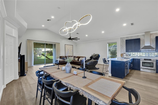 dining area featuring ceiling fan, sink, a wealth of natural light, and light hardwood / wood-style flooring