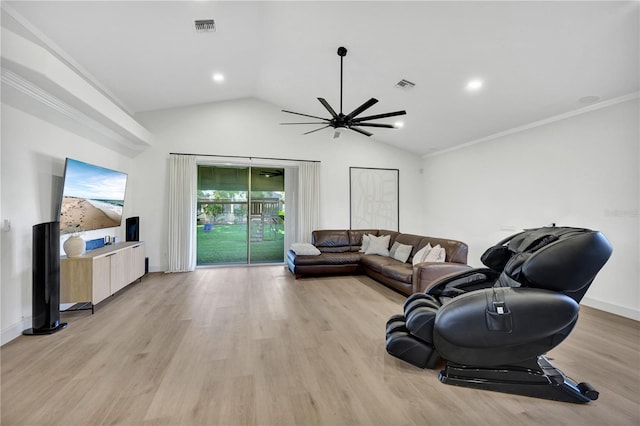 living room with light wood-type flooring, vaulted ceiling, and crown molding