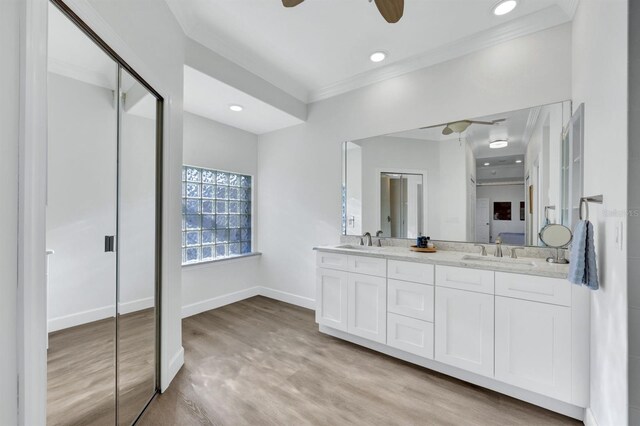 bathroom featuring ceiling fan, wood-type flooring, vanity, and crown molding