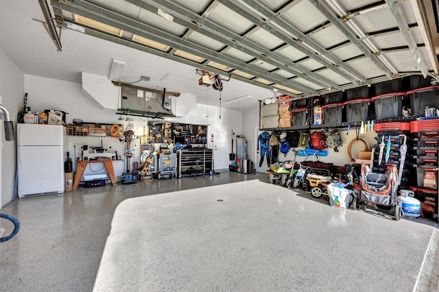 garage with a workshop area and white fridge