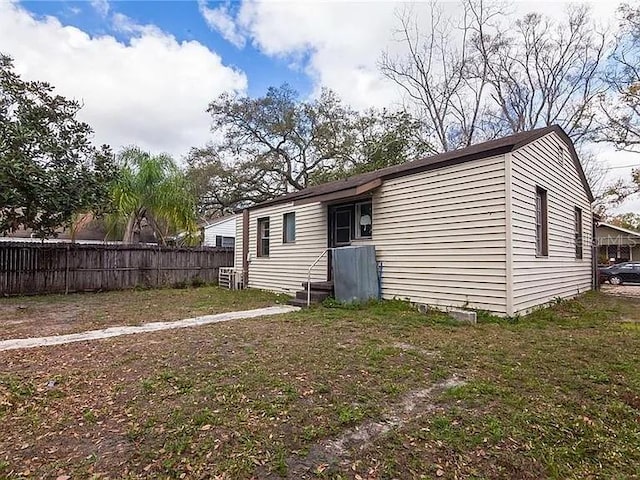 rear view of property with a lawn