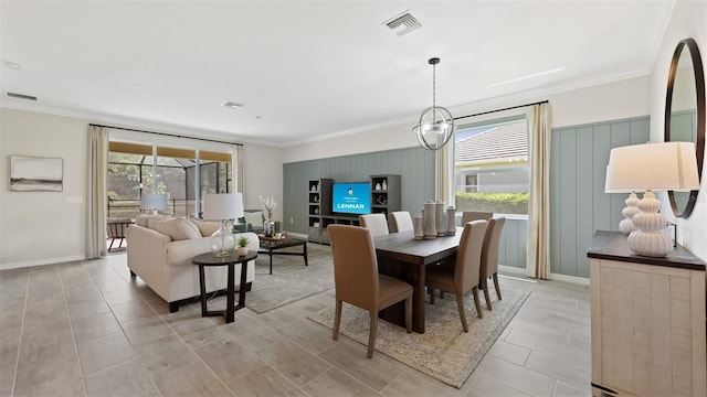 dining area featuring crown molding and a chandelier