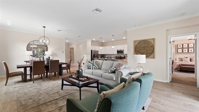 living room featuring ornamental molding and a chandelier