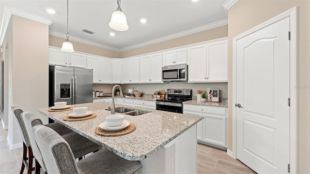 kitchen with white cabinetry, sink, an island with sink, and appliances with stainless steel finishes