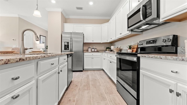 kitchen with white cabinetry, light stone countertops, decorative light fixtures, and stainless steel appliances