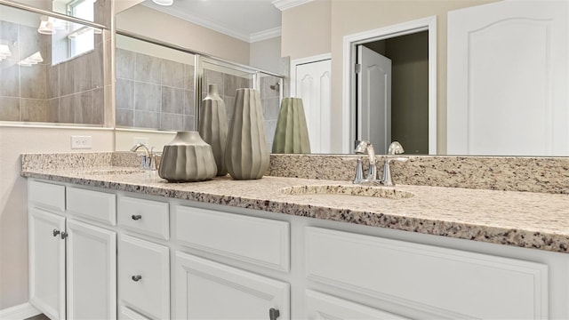 bathroom with crown molding, vanity, and walk in shower