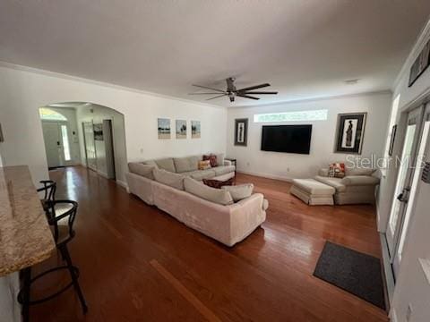 living room featuring ceiling fan, crown molding, and dark hardwood / wood-style floors