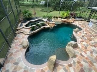 view of pool featuring a lanai and a patio area