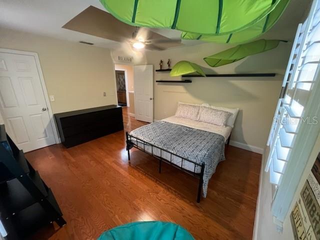 bedroom featuring ceiling fan and wood-type flooring