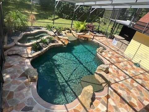 view of pool with a lanai and a patio area