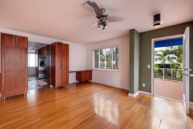 interior space with ceiling fan and light hardwood / wood-style flooring