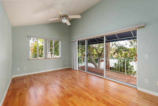 empty room with light wood-type flooring, ceiling fan, and vaulted ceiling