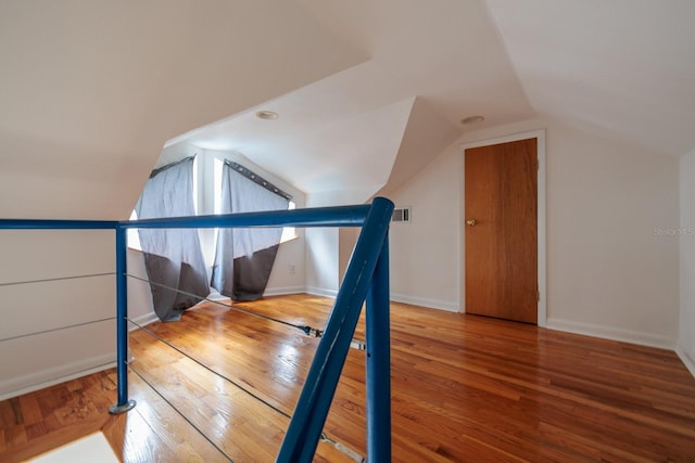 bonus room featuring vaulted ceiling and hardwood / wood-style flooring