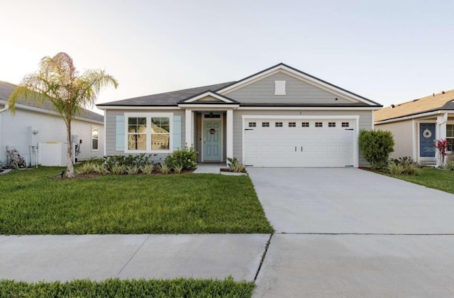 ranch-style home featuring a front lawn and a garage