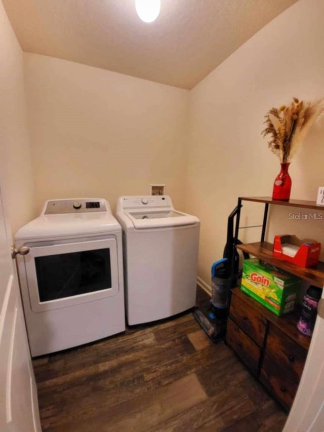 laundry room featuring washer and clothes dryer and dark hardwood / wood-style floors