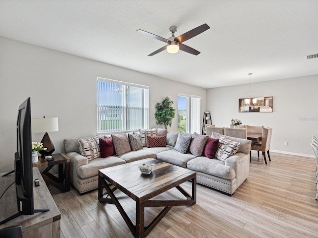 living room with ceiling fan and light hardwood / wood-style floors