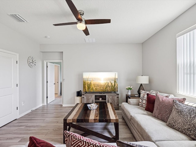 living room with ceiling fan and light hardwood / wood-style floors