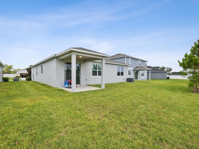 back of property with a patio area, central AC unit, and a lawn