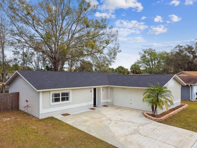 ranch-style house featuring a front yard and a garage