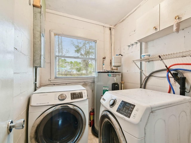 washroom with electric water heater, light tile patterned floors, and separate washer and dryer