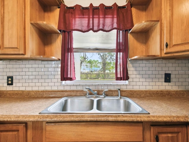 kitchen featuring backsplash and sink