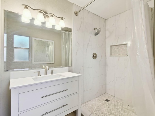 bathroom featuring walk in shower and vanity