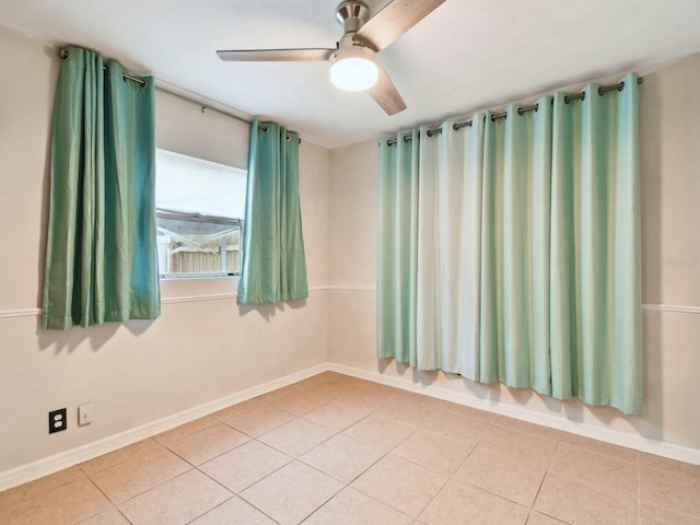 spare room with ceiling fan and tile patterned floors