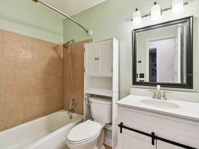 full bathroom featuring toilet, vanity, and tiled shower / bath