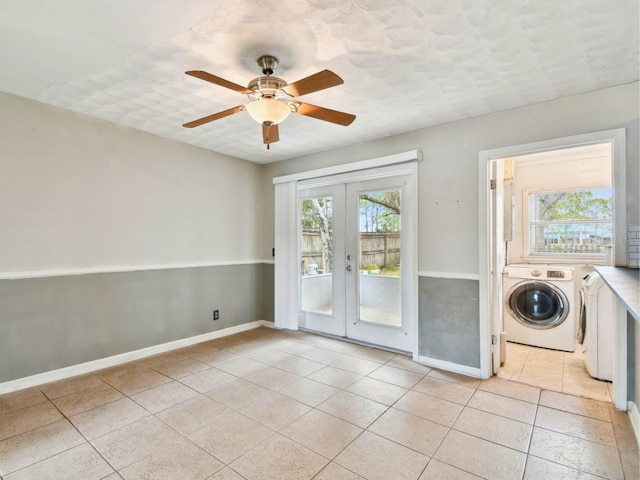 clothes washing area with light tile patterned flooring, ceiling fan, washer and dryer, and french doors