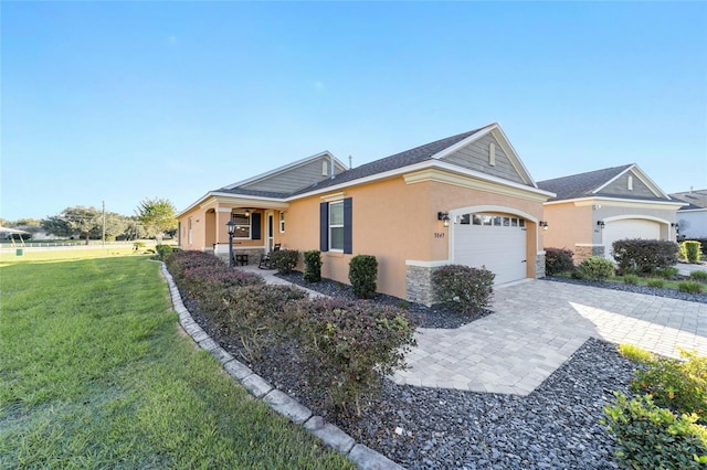 single story home featuring a garage and a front lawn