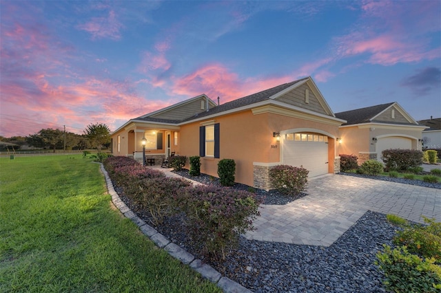 view of front of home featuring a yard and a garage