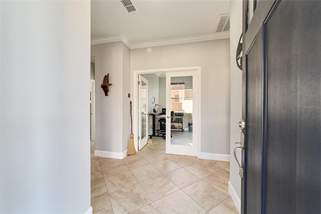 entrance foyer featuring french doors, ornamental molding, and light tile patterned flooring