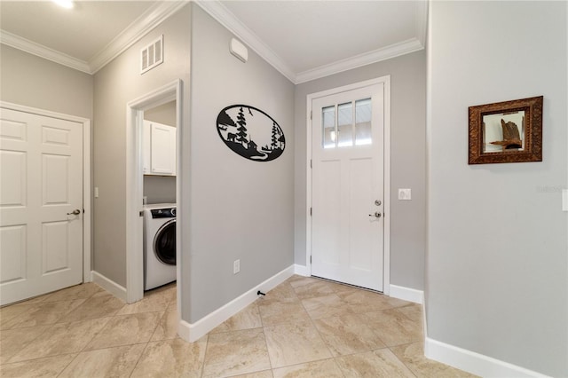 entrance foyer featuring washer / dryer and ornamental molding