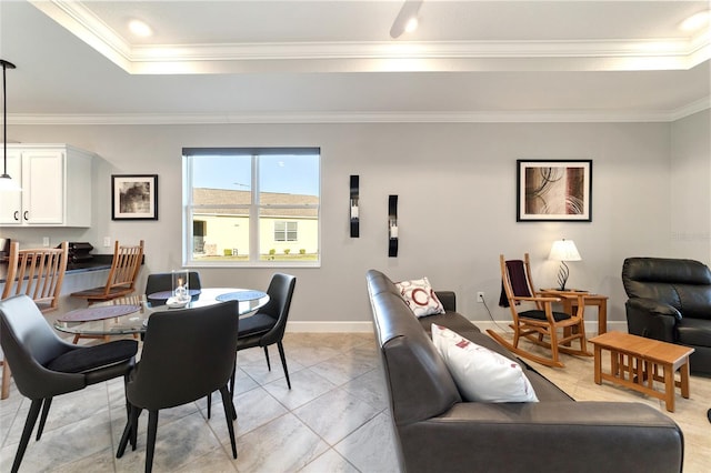 dining room with a tray ceiling and ornamental molding