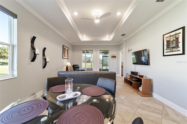 tiled dining room with ceiling fan, crown molding, and a tray ceiling