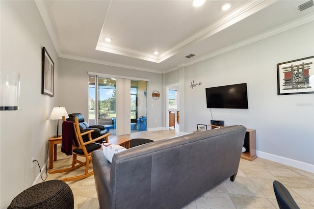 tiled living room featuring crown molding and a raised ceiling