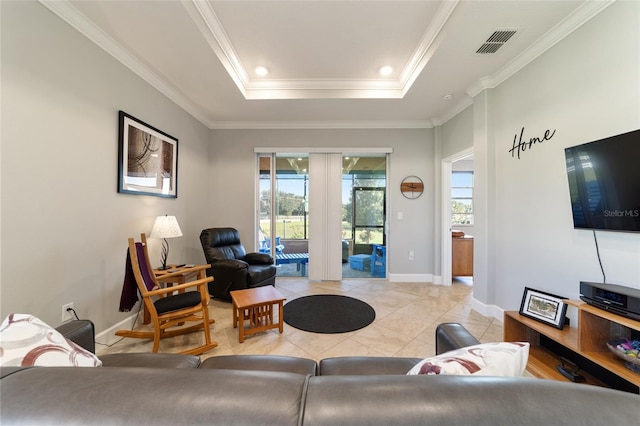 living room with ornamental molding, light tile patterned floors, and a tray ceiling