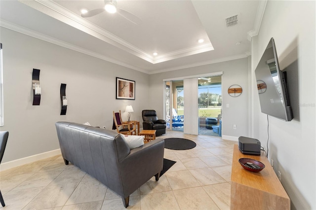 tiled living room with crown molding, ceiling fan, and a raised ceiling