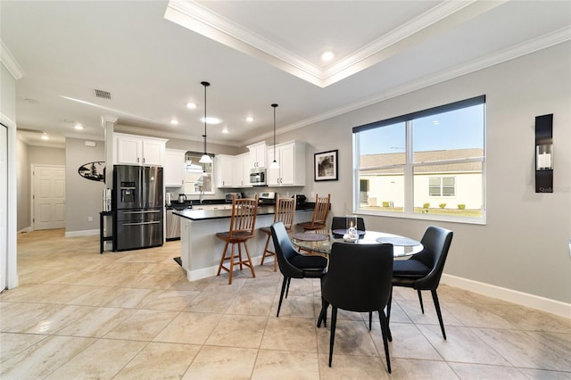 dining area with light tile patterned floors and ornamental molding