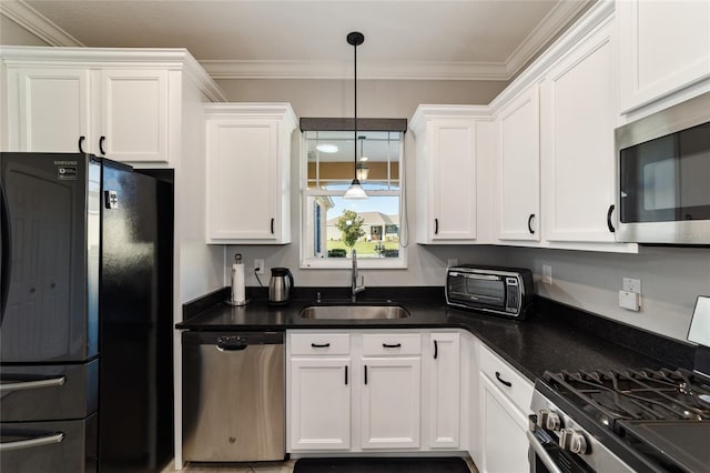 kitchen featuring crown molding, appliances with stainless steel finishes, white cabinetry, hanging light fixtures, and sink