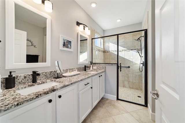 bathroom with tile patterned flooring, an enclosed shower, and vanity