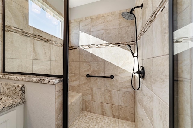 bathroom with tiled shower