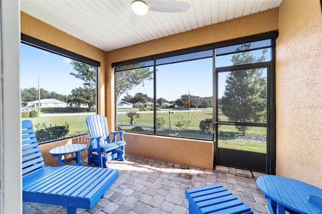 sunroom / solarium with ceiling fan and a healthy amount of sunlight